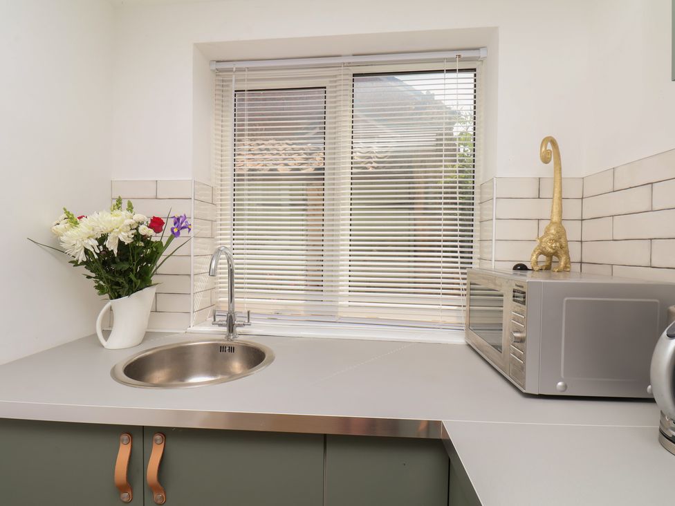 A kitchen with a sink and microwave at 174 High Street Marske-By-The-Sea