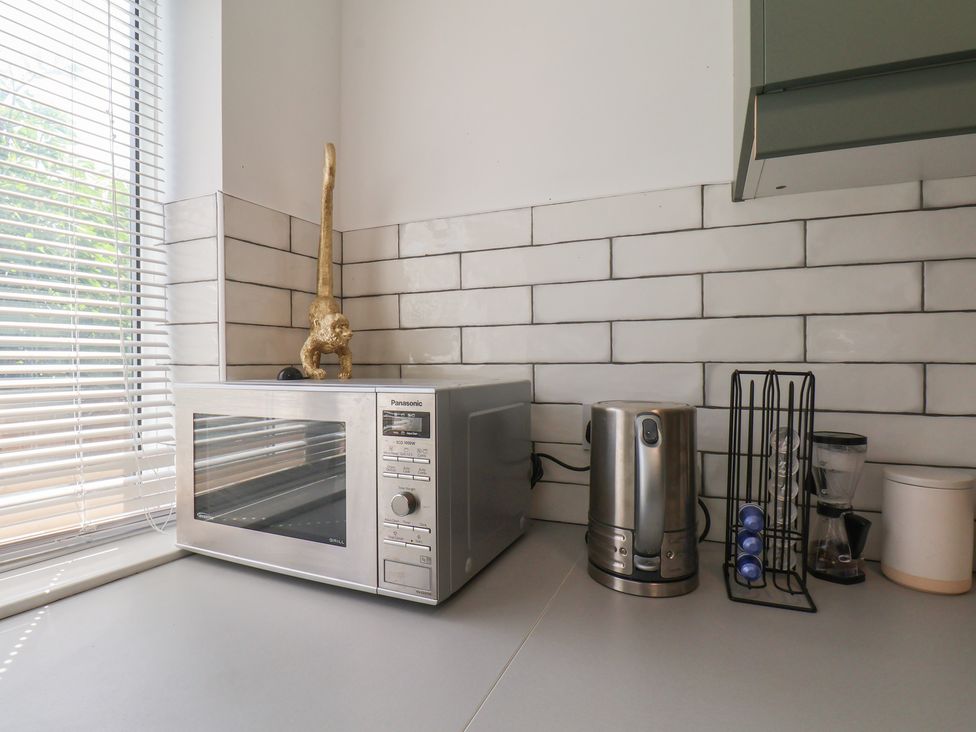 A kitchen with a microwave and kettle at 174 High Street Marske-By-The-Sea