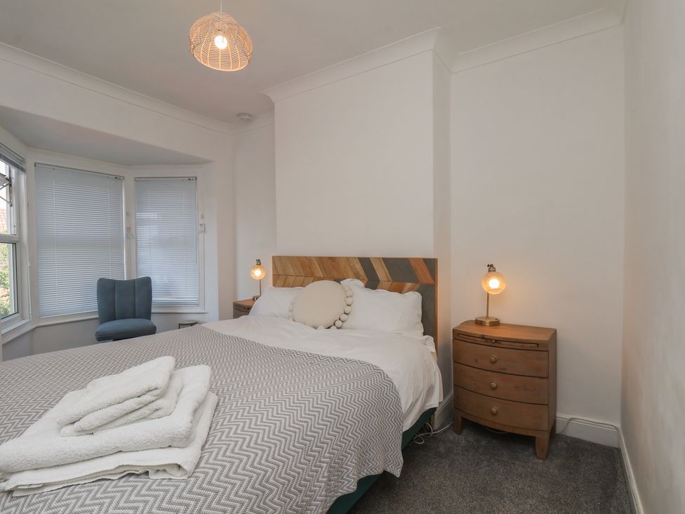 A bedroom with a bed and bedside table at 174 High Street in Marske-By-The-Sea