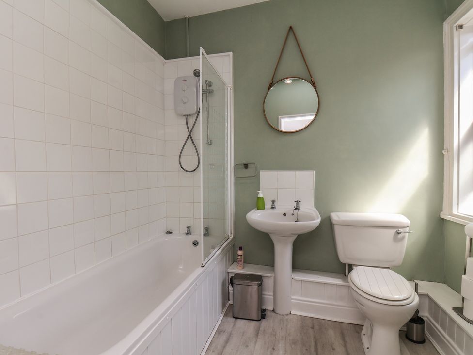 A bathroom with a bathtub, shower, toilet, and sink at 174 High Street in Marske-By-The-Sea