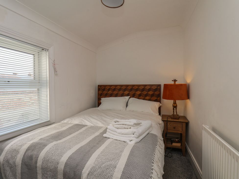 A bedroom with a bed and a bedside table at 174 High Street Marske-By-The-Sea