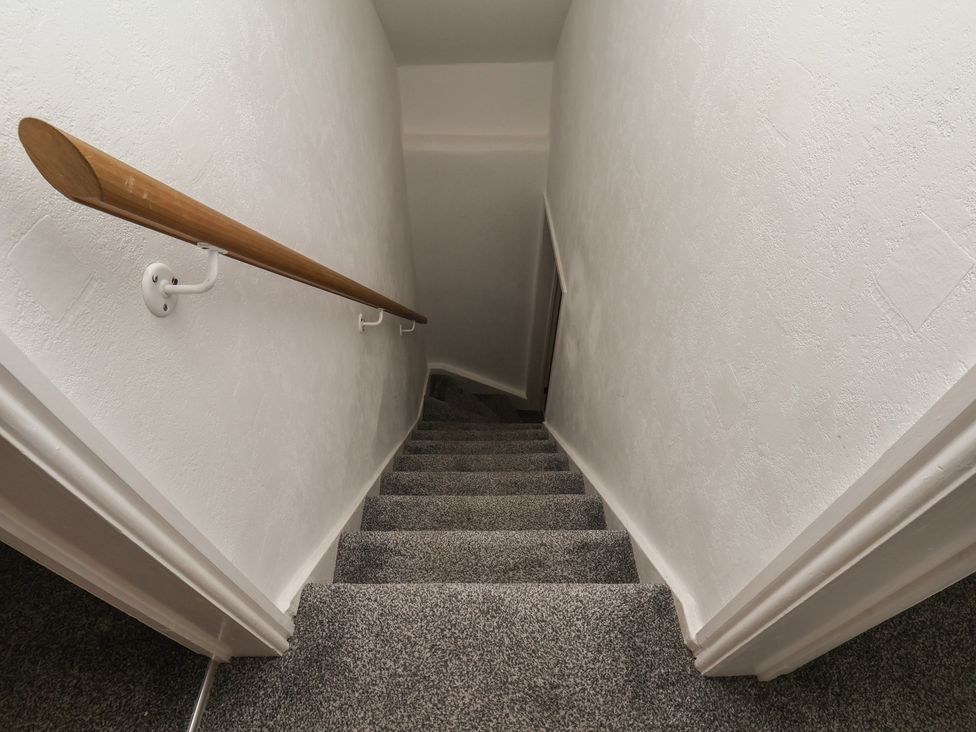 A staircase with a handrail at 174 High Street Marske-By-The-Sea