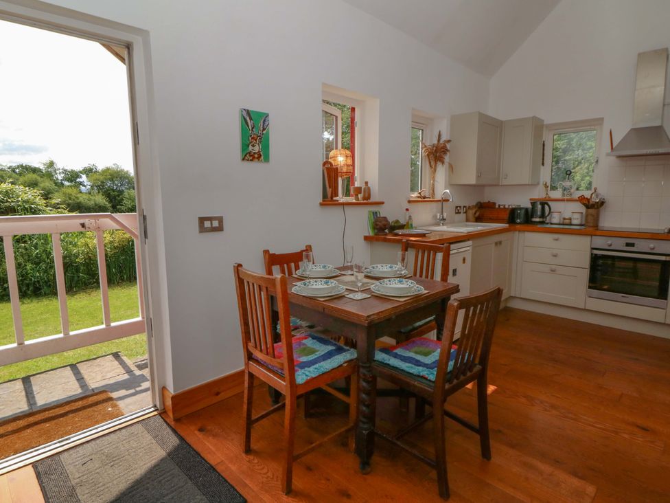 A kitchen with a table and chairs at Delfryn in Llandeilo