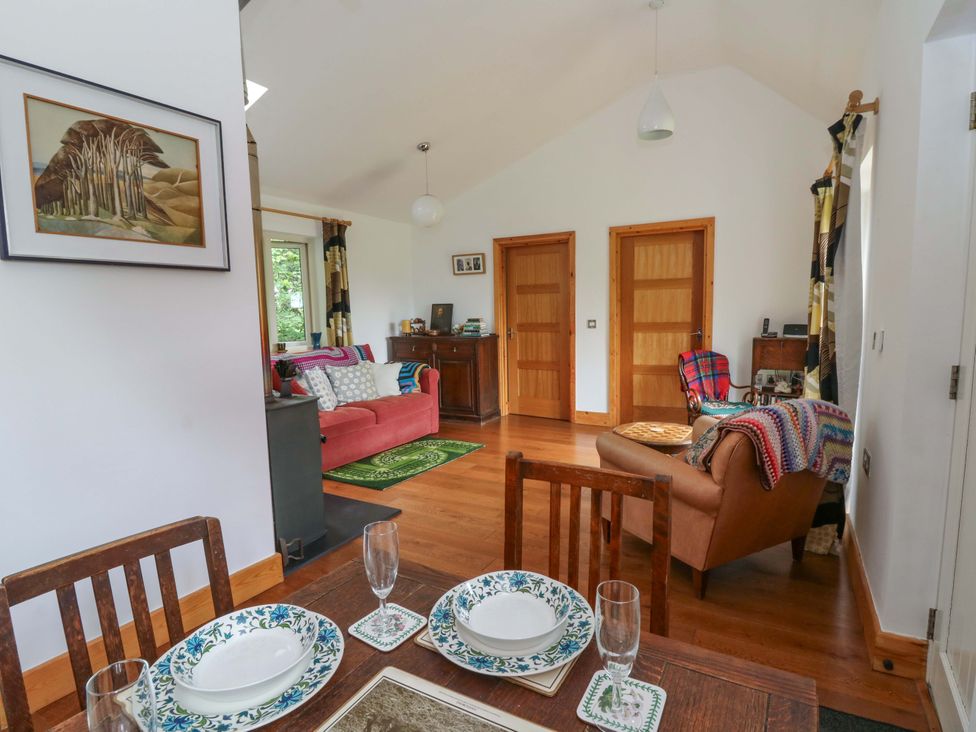 A living room with a table and chairs at Delfryn in Llandeilo
