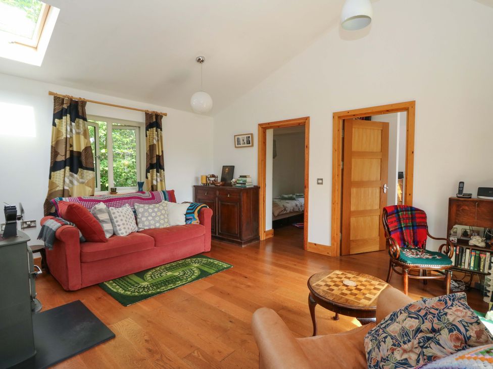 A living room with a sofa and a coffee table at Delfryn in Llandeilo