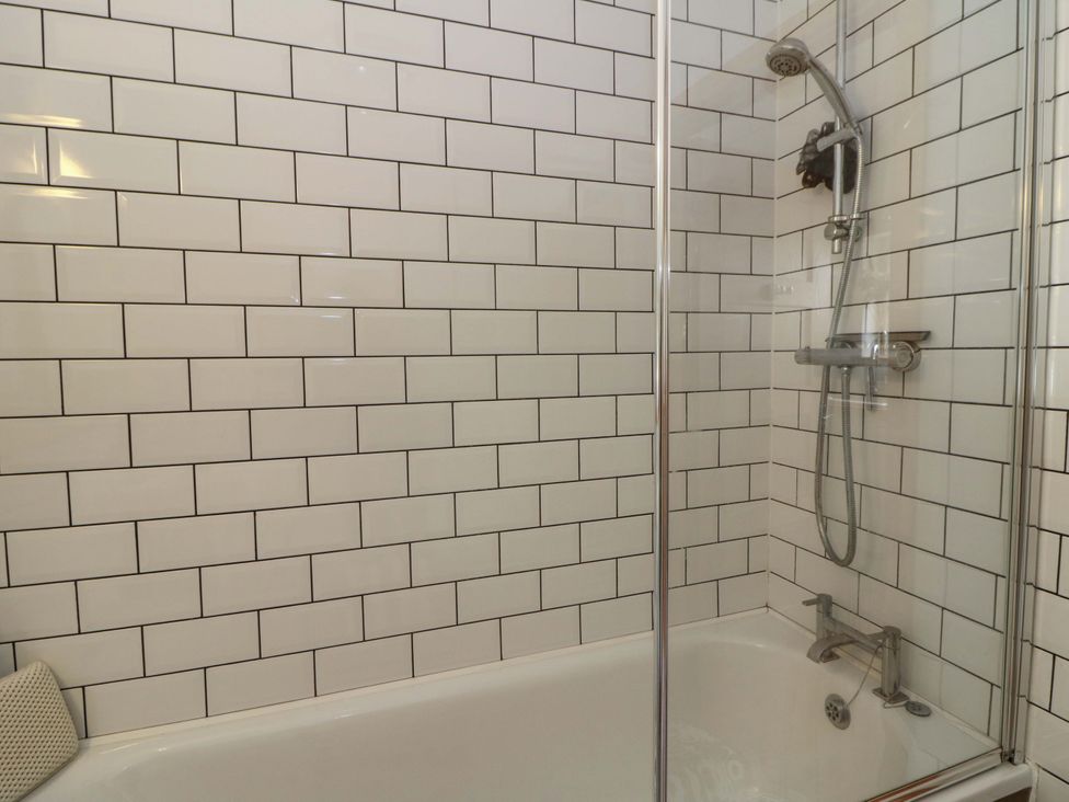 A bathroom with a shower and bathtub at Delfryn in Llandeilo
