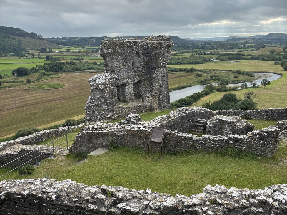 A castle ruin with grass and river view at Delfryn Llandeilo near Llandeilo