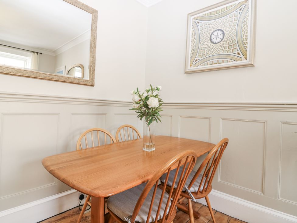 A dining room with a table and chairs at 11A High Street Jedburgh