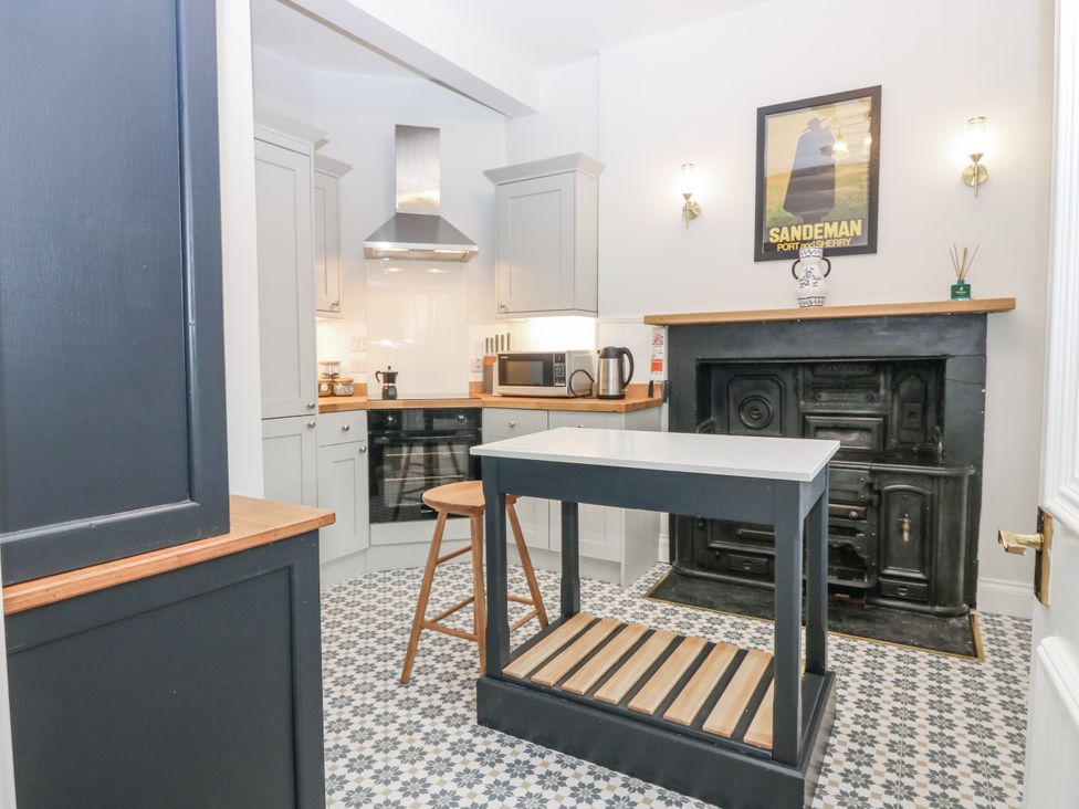 A kitchen with a counter and bar stool at 11A High Street Jedburgh