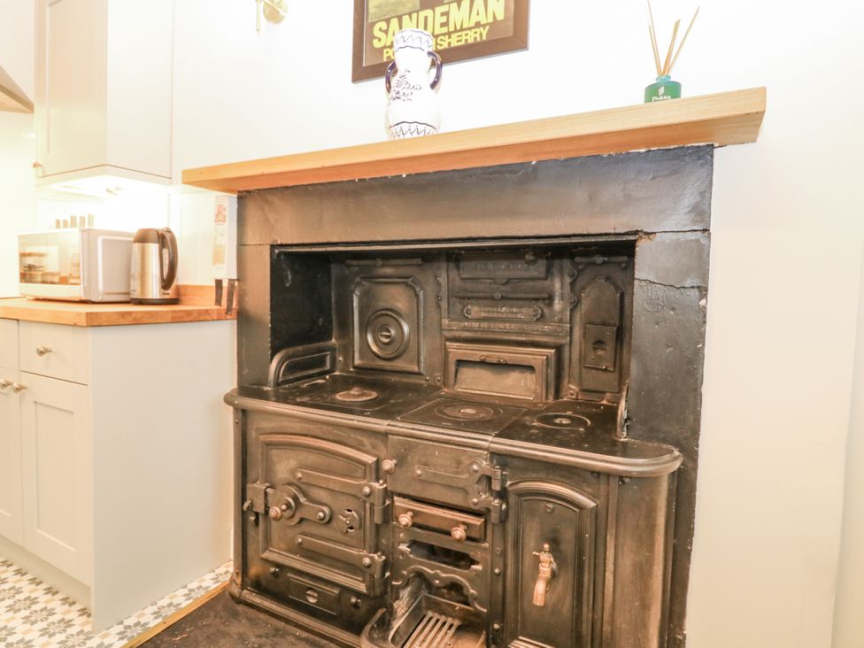 A stove and kitchen appliances in the kitchen at 11A High Street Jedburgh