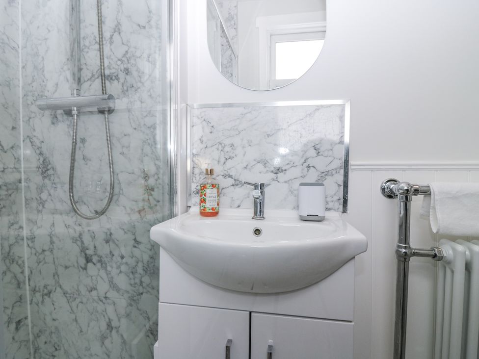 A bathroom with a shower and sink at 11A High Street in Jedburgh