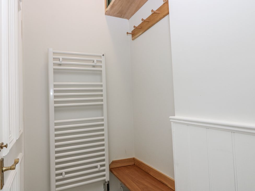 A utility room with a towel radiator and hooks at 11A High Street in Jedburgh