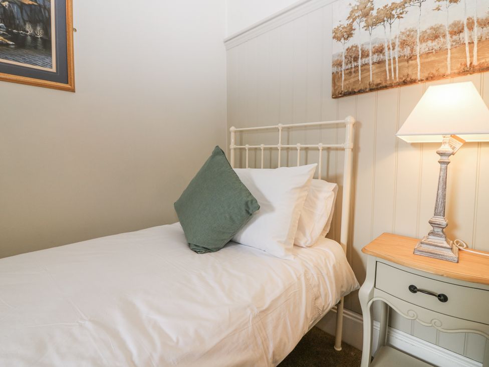 A bedroom with a bed and lamp at 11A High Street, Jedburgh