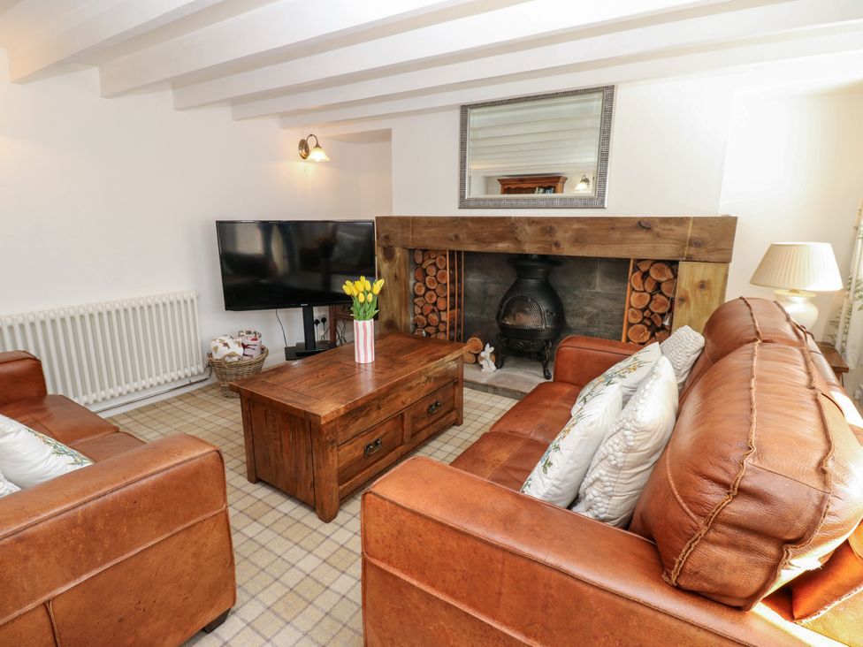 A living room with a coffee table and television at The Museum in Nenthead