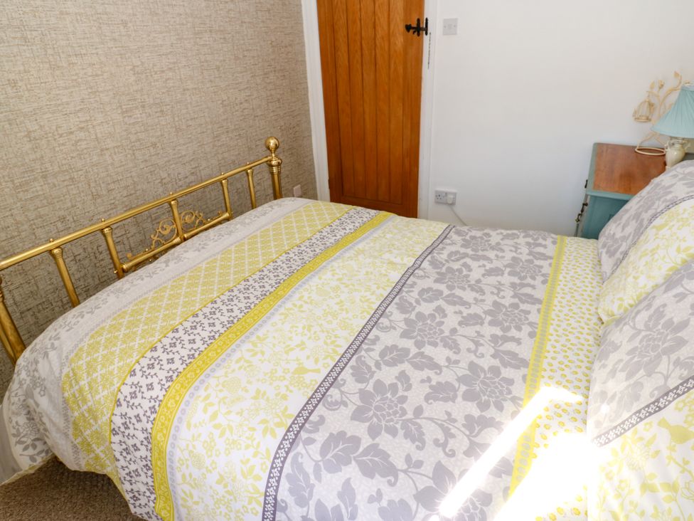 A bedroom with a bed and a bedside table at The Museum in Nenthead