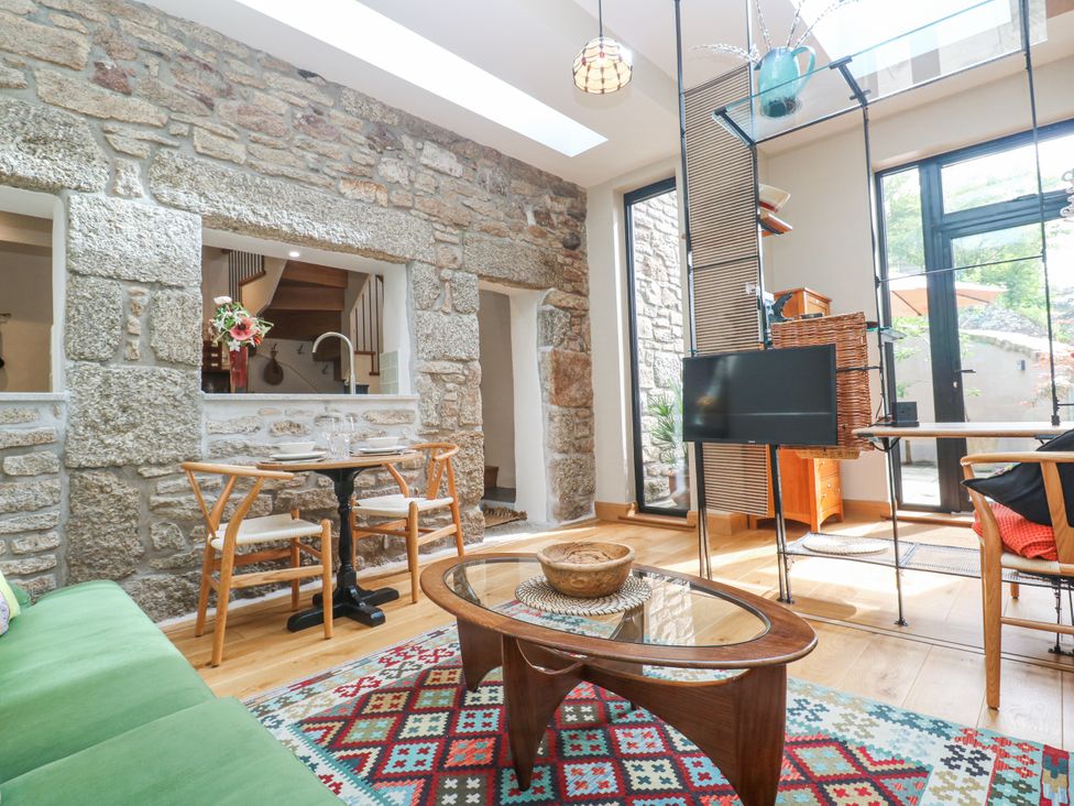 A living room with a coffee table and chairs at The Stables in St Just