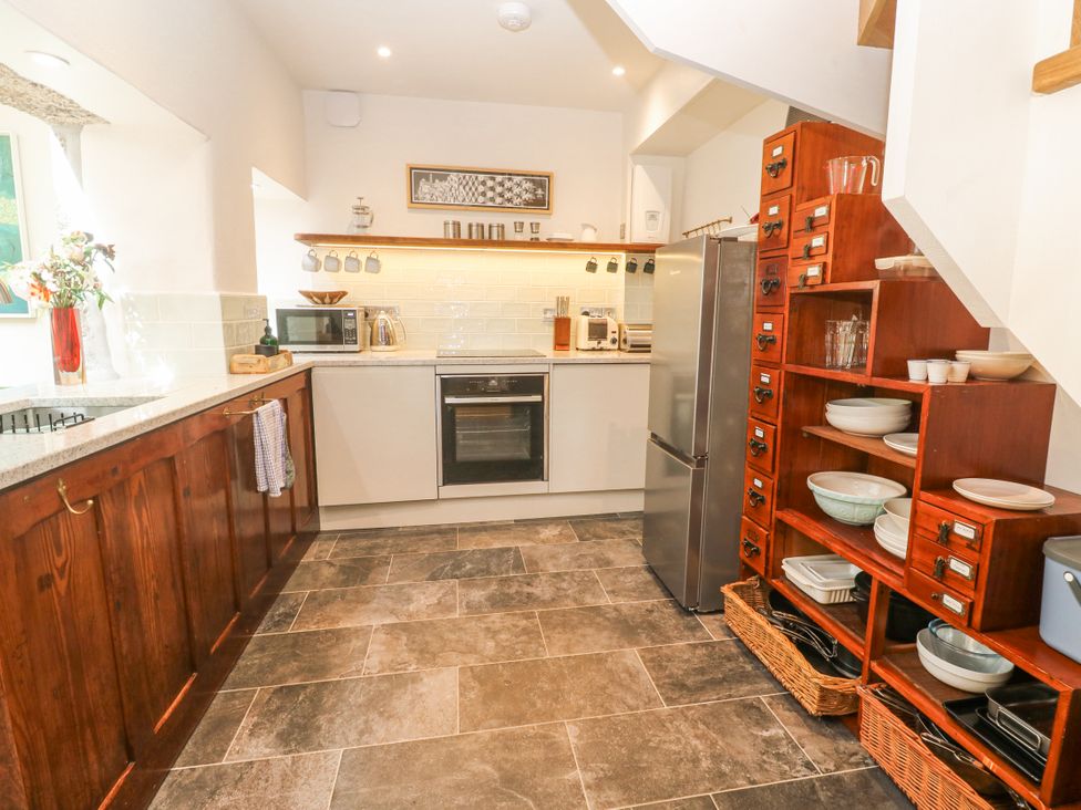 A kitchen with appliances and dishes at The Stables in St Just