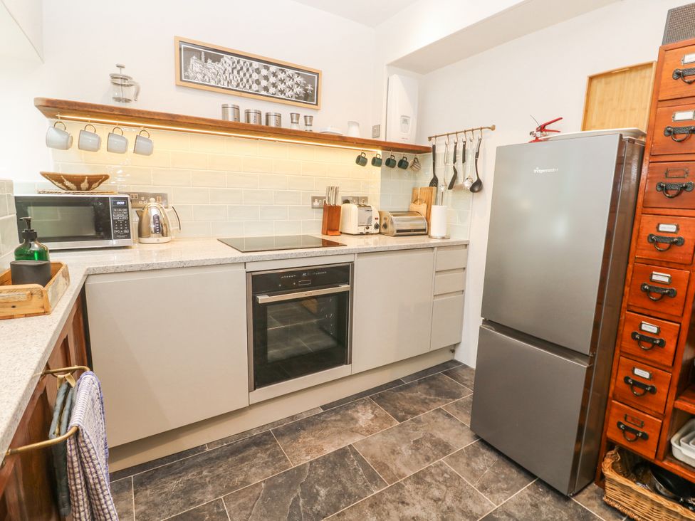 A kitchen with appliances and storage at The Stables in St Just