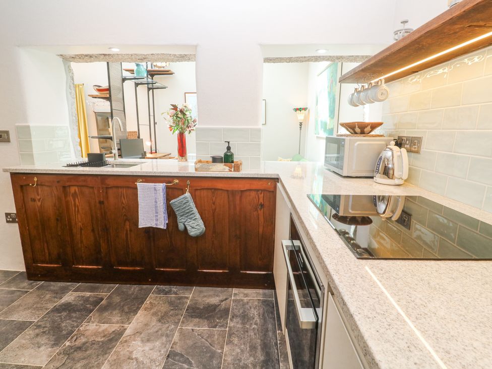 A kitchen with countertops and appliances at The Stables in St Just
