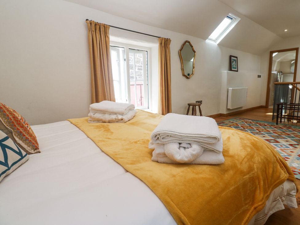 A bedroom with a bed and blankets at The Stables in St Just