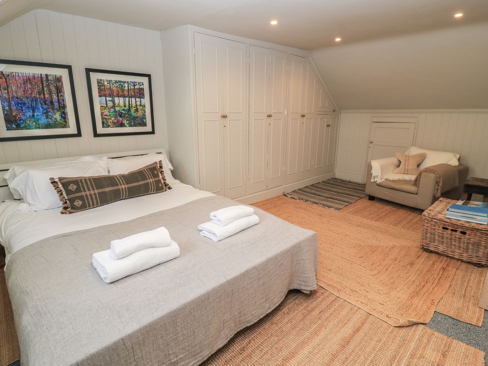 A bedroom with a bed and artwork at Cotswold House in Moreton-In-Marsh