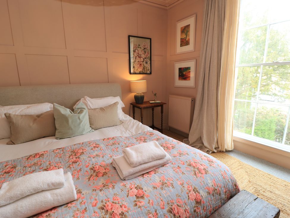A bedroom with a bed and artworks at Cotswold House Moreton-In-Marsh