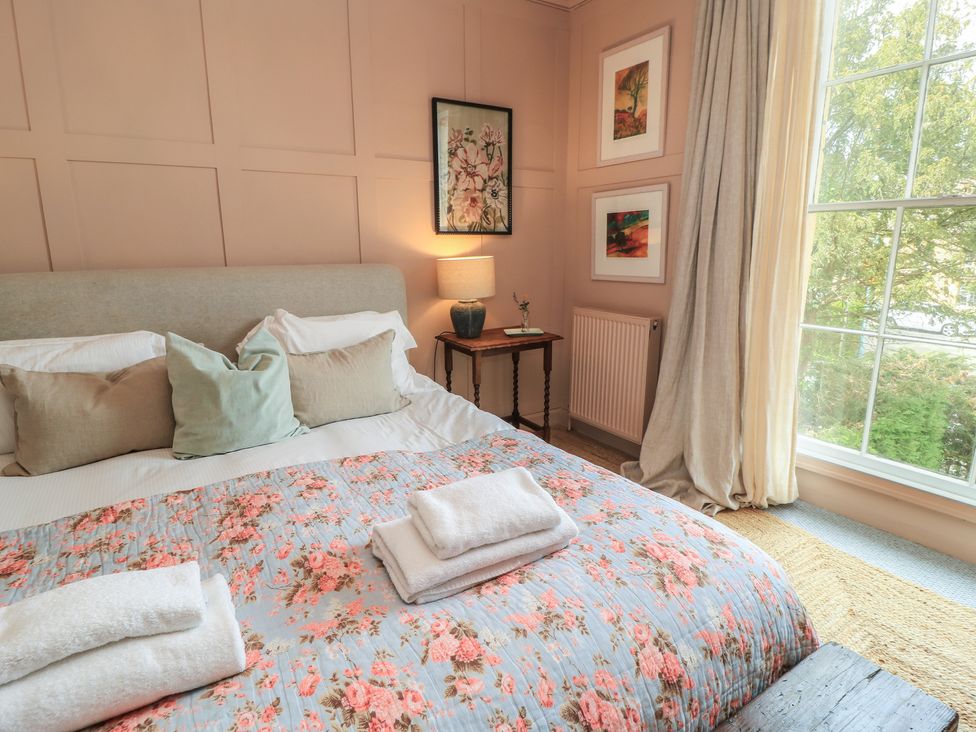 A bedroom with a bed and artwork at Cotswold House in Moreton-In-Marsh