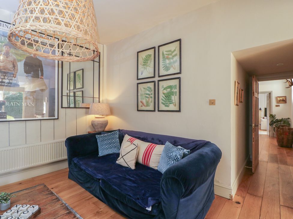 A living room with a sofa and wall art at Cotswold House in Moreton-In-Marsh