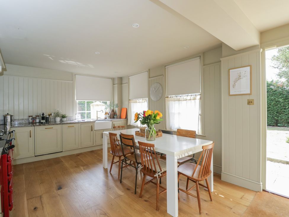 A kitchen with a table and chairs at Cotswold House Moreton-In-Marsh