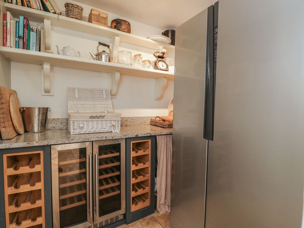 A kitchen with a refrigerator and wine cooler at Cotswold House in Moreton-In-Marsh