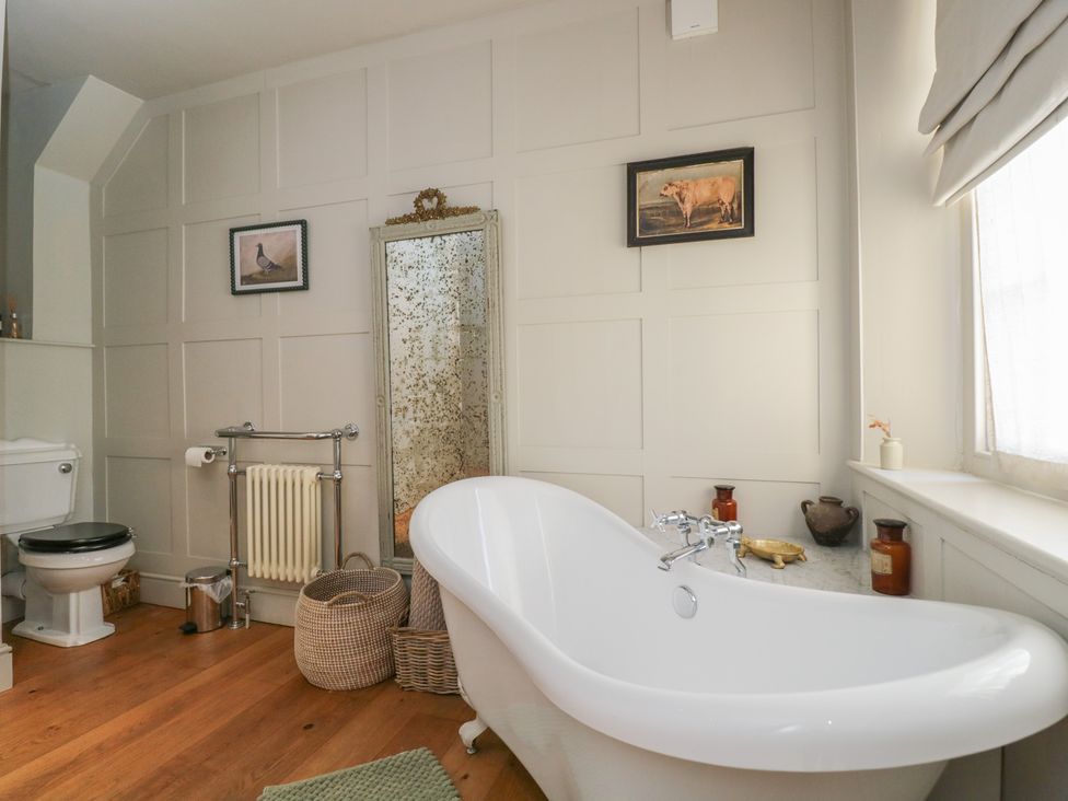 A bathroom with a bathtub and toilet at Cotswold House Moreton-In-Marsh