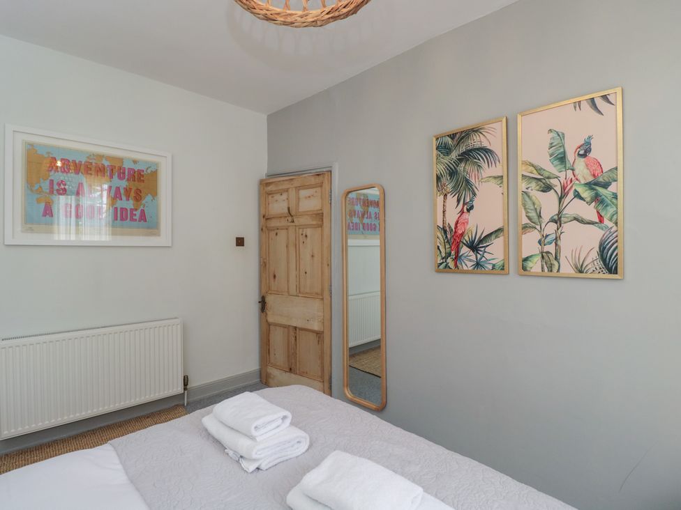 A bedroom with a bed and artworks at Cotswold House in Moreton-In-Marsh