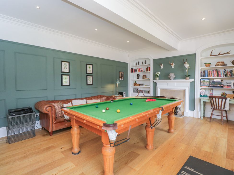 A snug with a snooker table and a sofa at Cotswold House in Moreton-In-Marsh