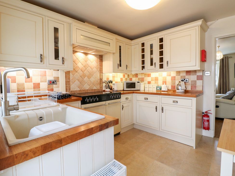 A kitchen with a sink and appliances at Rose Cottage in Hartington