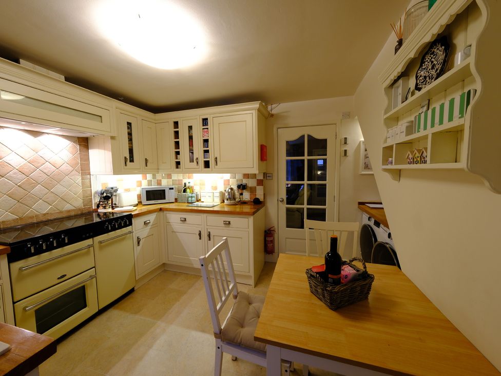 A kitchen with cabinets and appliances at Rose Cottage in Hartington