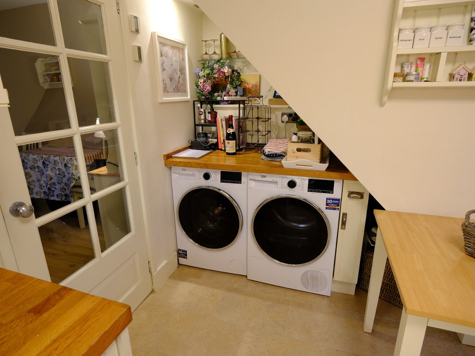 A laundry room with a washing machine and dryer at Rose Cottage in Hartington