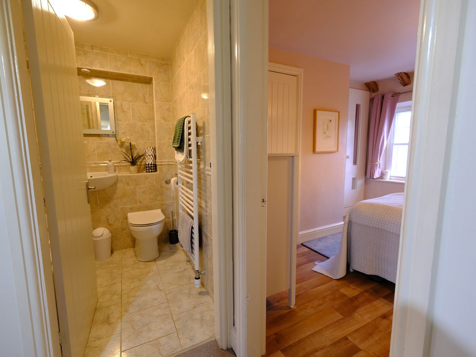A bathroom with a toilet and sink at Rose Cottage in Hartington