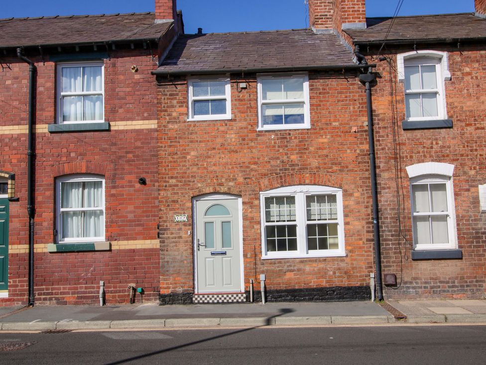 A house with brick walls and windows at Riverside Cottage in Shrewsbury
