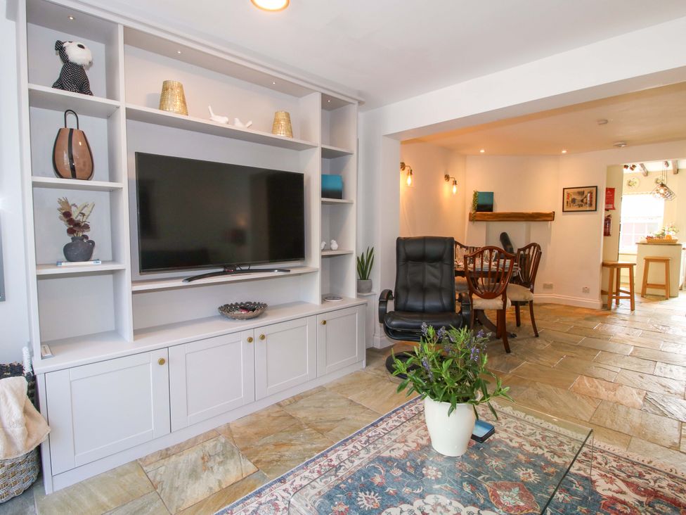 A living room with a television and seating area at Riverside Cottage in Shrewsbury