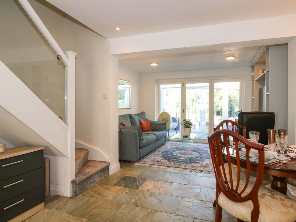A living room with a sofa and dining table at Riverside Cottage Shrewsbury