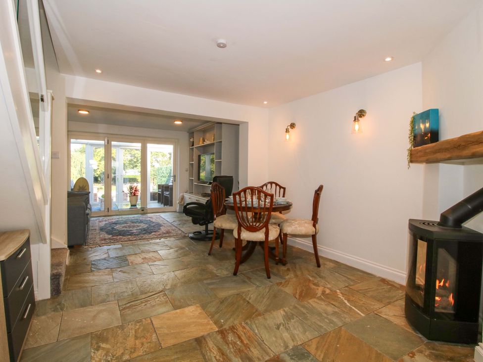 A dining room with a table and chairs at Riverside Cottage in Shrewsbury