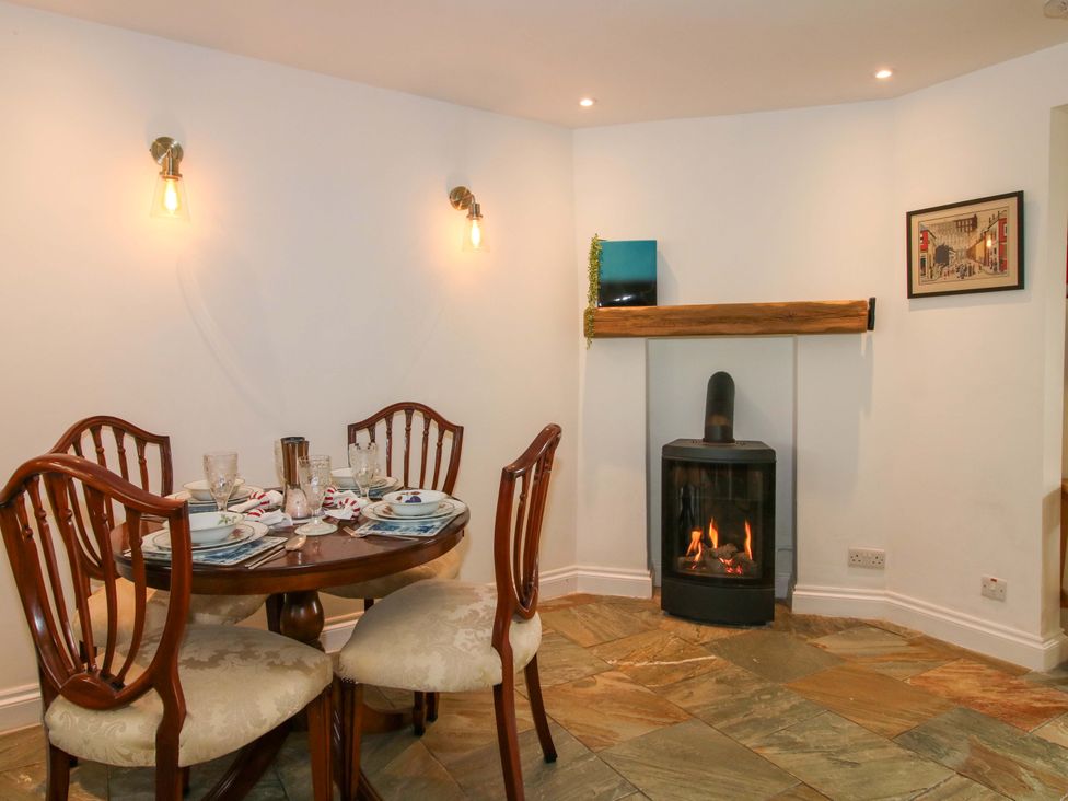 A dining room with a table and chairs at Riverside Cottage in Shrewsbury