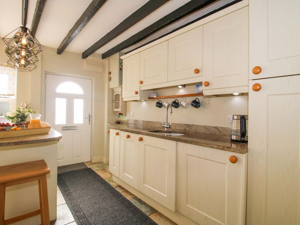A kitchen with countertops and cupboards at Riverside Cottage in Shrewsbury