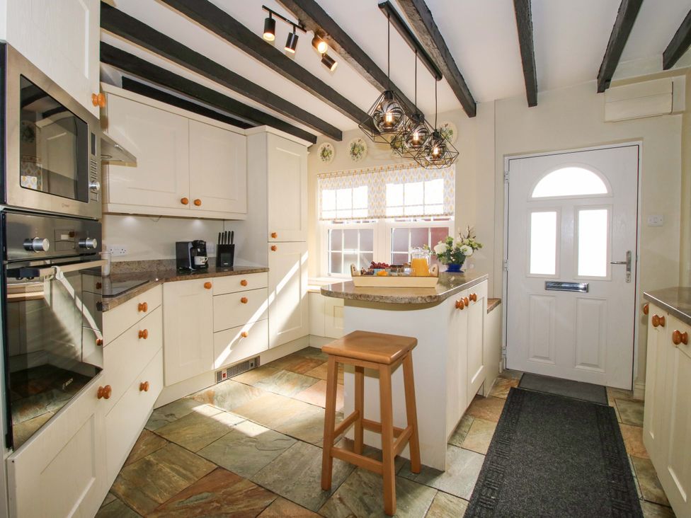 A kitchen with cabinets and a countertop at Riverside Cottage in Shrewsbury