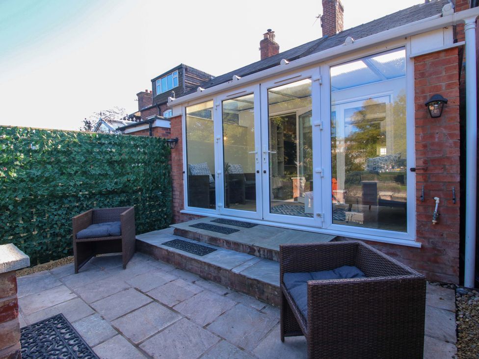 A garden with stone steps and chairs at Riverside Cottage in Shrewsbury