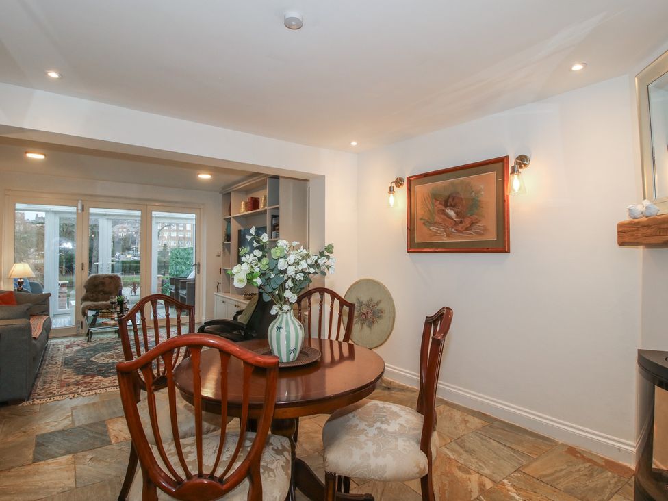 A dining room with a table and chairs at Riverside Cottage in Shrewsbury