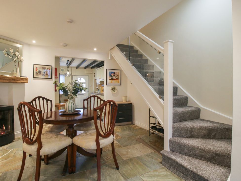 A dining room with a table and chairs at Riverside Cottage in Shrewsbury