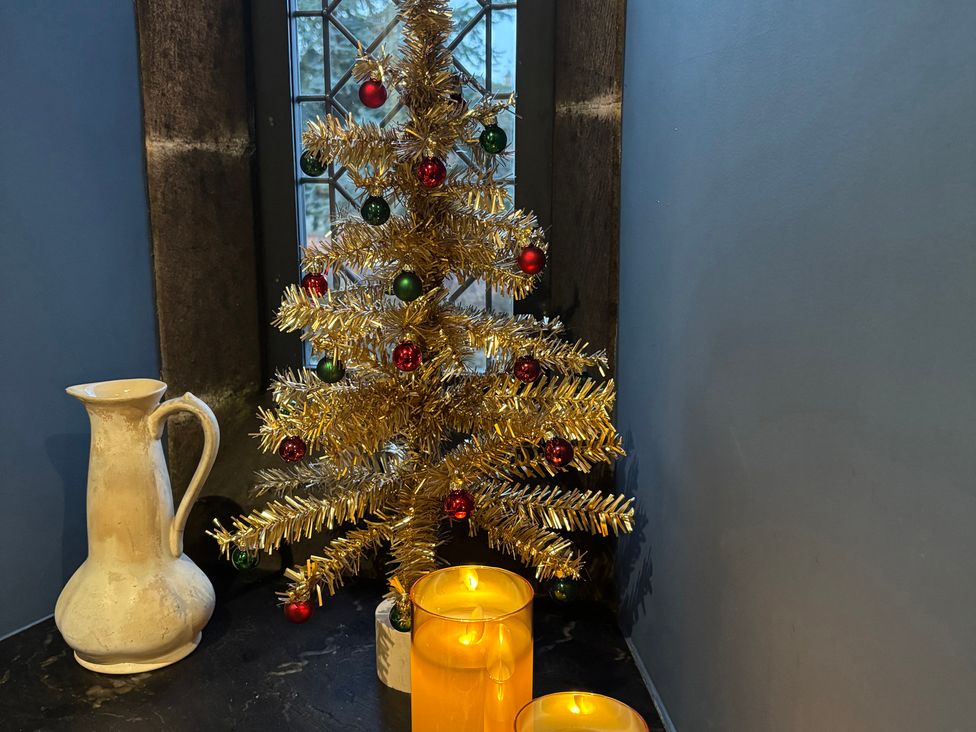 A Christmas tree and candles near a window at St Edmunds Church in Fraisthorpe