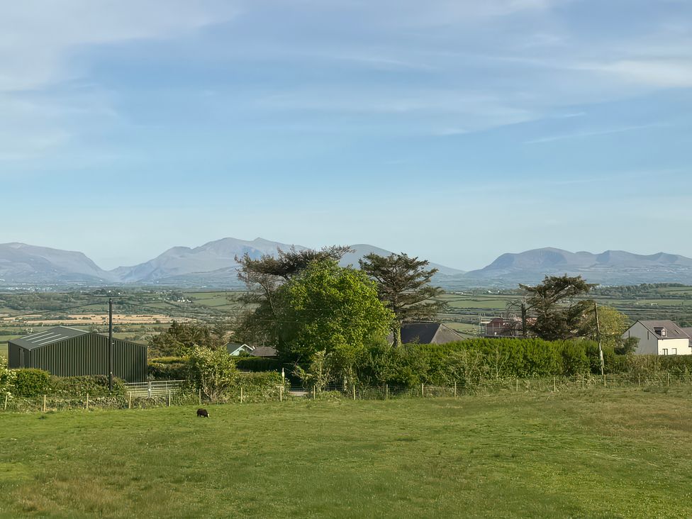 A view of mountains and fields near Llangristiolus at 15 Llys Tegeirian Llangristiolus near Llangefni