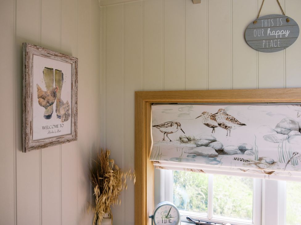 A kitchen with a window and decorative elements at Herbie's Shepherds Hut at Shepherds Lodge Retreat and Wellness Bottesford near Redmile and Vale of Belvoir